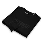 Folded black t-shirt with text on a white background