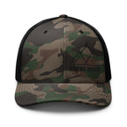 Camouflage trucker hat with black mesh and brand logo on a white background